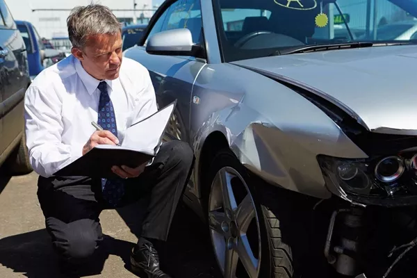 checking car after accident