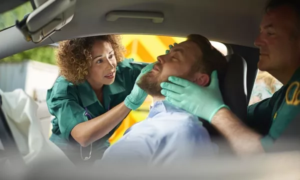 Relate the EMT team what you’ve done and who needs the most care from them woman is checking an injured man