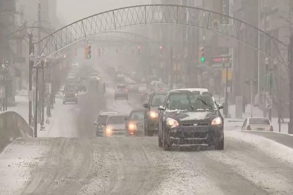 Snowing road with cars