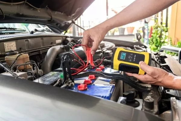 A man charging his car battery