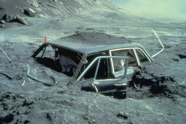 A picture of a car buried in ash