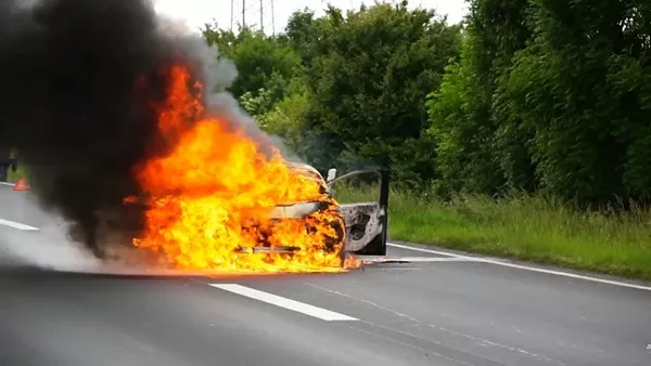Car burning on road