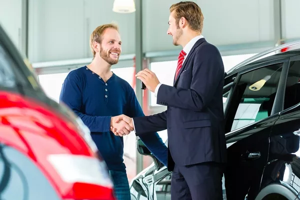 car dealer talking to his customer