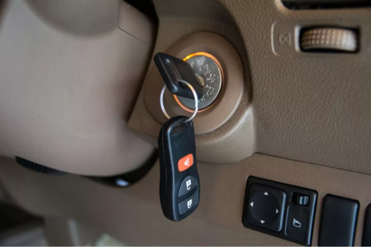 A picture of a car's dashboard showing keys inserted into the ignition switch