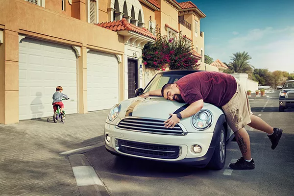 a man holding a car