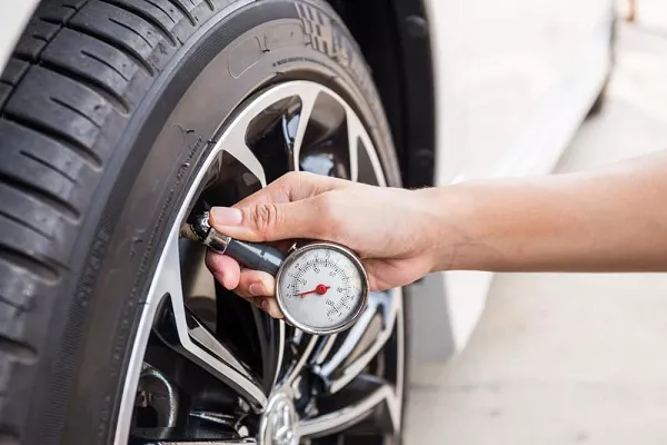 Man checking tire pressure