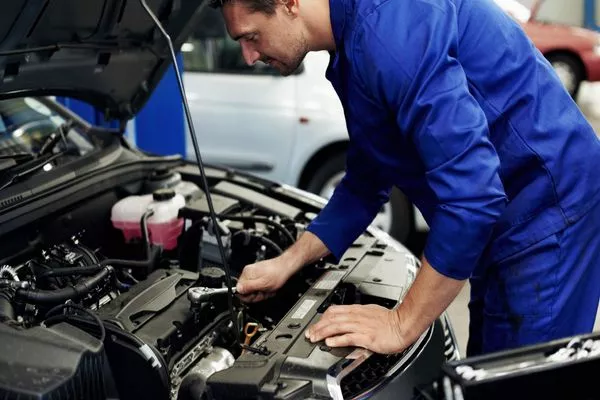 car mechanic checking a car engine