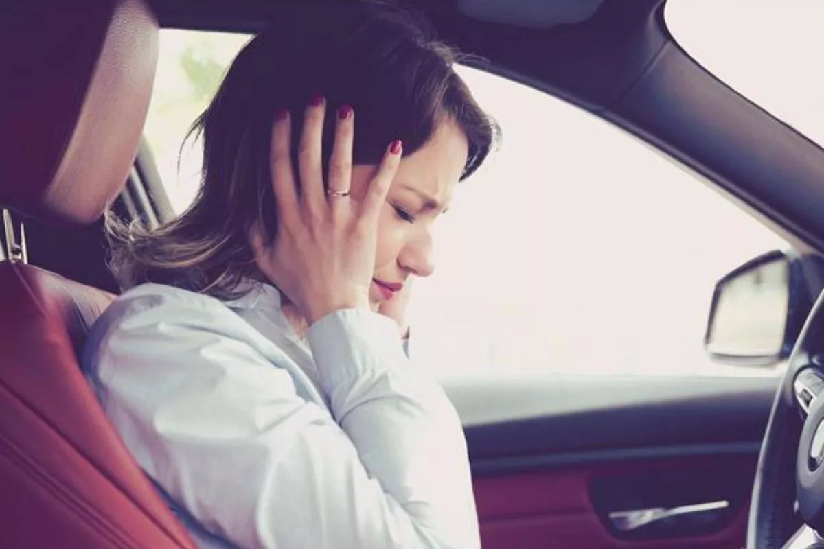 A woman covering her ears
