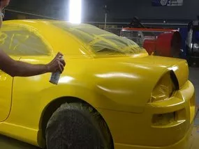 A main painting a car yellow