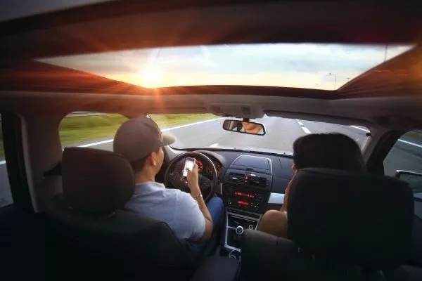 A man using his phone while driving