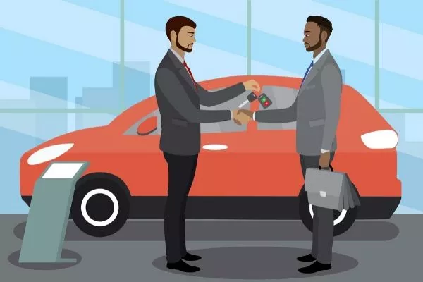 A picture of a sales person handing over car keys