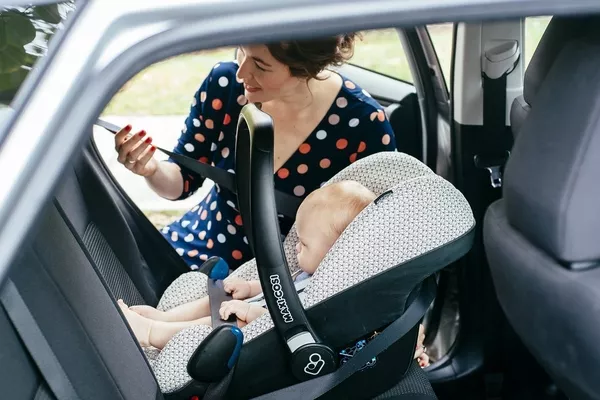 woman installing a car baby seat