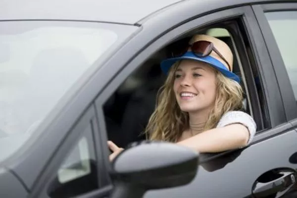 A cool and well-ventilated car help ease car sickness Woman in the car with open window