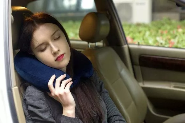 Trying to take a nap might help if you are suffering from car sick Woman sleeping in the car