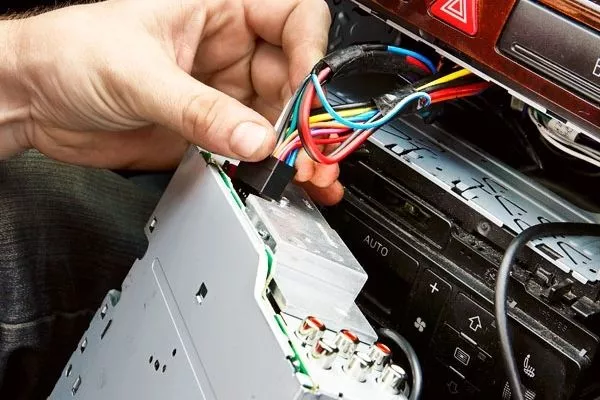 A man pulling out a car stereo