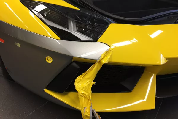 Silver car with yellow car wrapping material