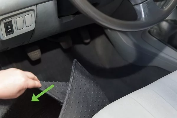 man removing the floormats