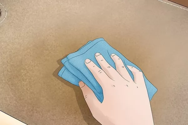 Man wiping the carpet using towel