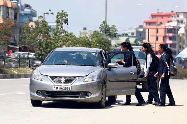 students riding a car