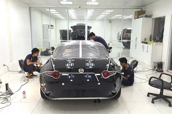 A picture of Ceramic Pro Philippines employees working on a car