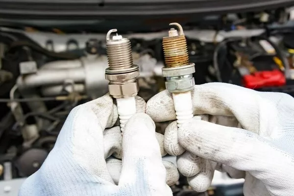 Man holding spark plugs