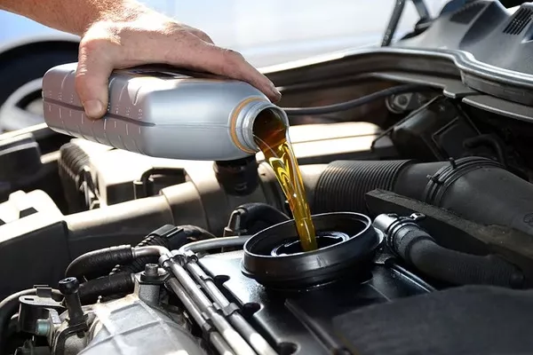 Man putting engine oil 