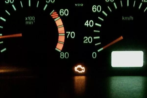 An illuminated check engine light in a digital instrument cluster