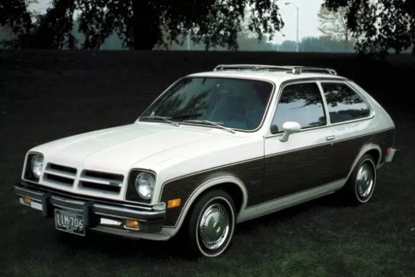A picture of a Chevy Chevette parked in a wooded area