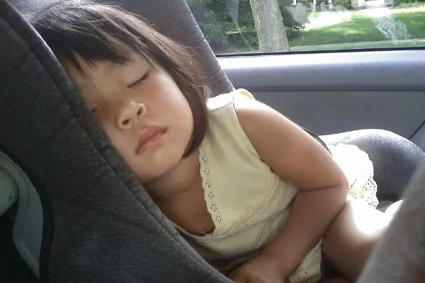 A girl sleeping in a car