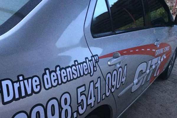 A City Driving School training vehicle with training vehicle markings A picture of a City Driving School training vehicle