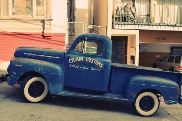 A picture of a classic truck properly parked facing uphill.