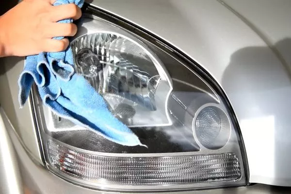 Man cleaning the headlights