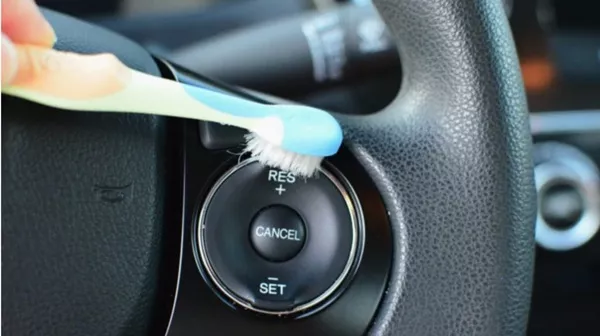 Cleaning car interior by toothbrush