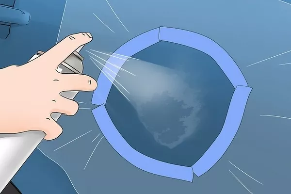 Man spraying aerosol in the car paint