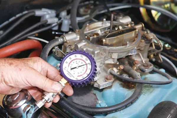 A picture of a guy using a compression measuring device