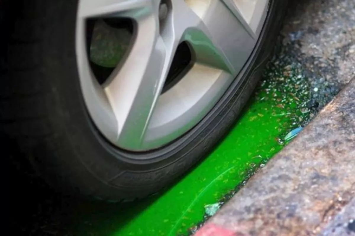 A picture of a car puking coolant