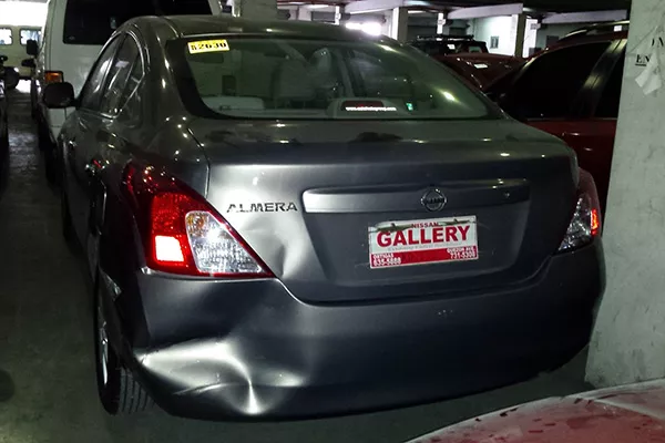 A picture of a heavily damaged, repossessed Nissan Almera
