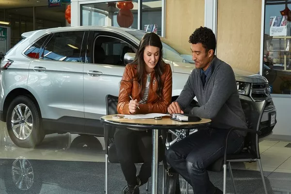 Potential car buyer talking to a dealer