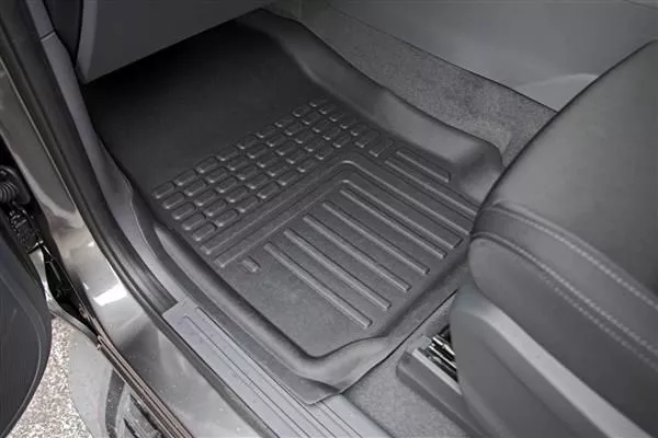 A picture of a deep dish floormat inside a car