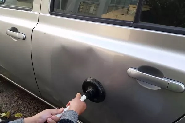 repairing car dent with plunger 