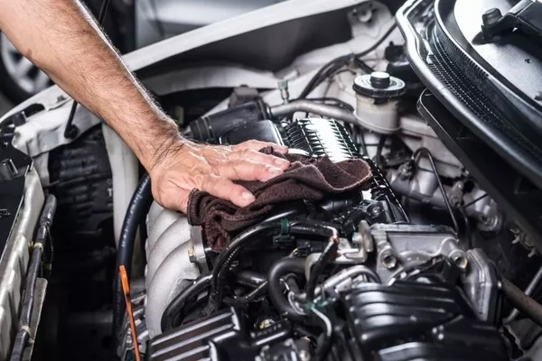 Man cleaning the engine bay