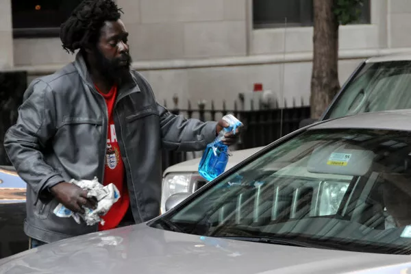Man cleaning the car windows