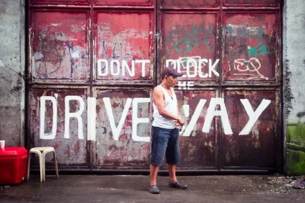 Man standing in front of drive way
