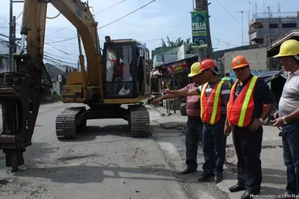 DPWH is their name and infrastructure is their game. A picture of DPWH personnel inspecting a road in the midst of repair