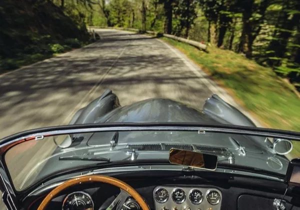 Despite the lack of modern amenities these old cars have bigger seats in the front and back behind an old car's wheel