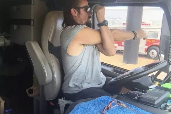 A picture of a trucker doing some arm streches