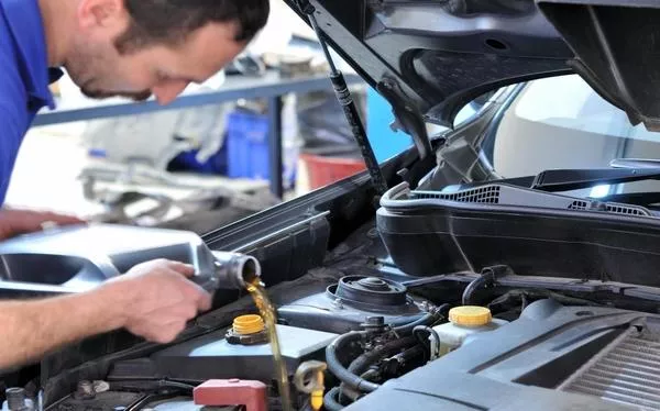 Regularly check the entire condition of your car a man checking a car engine