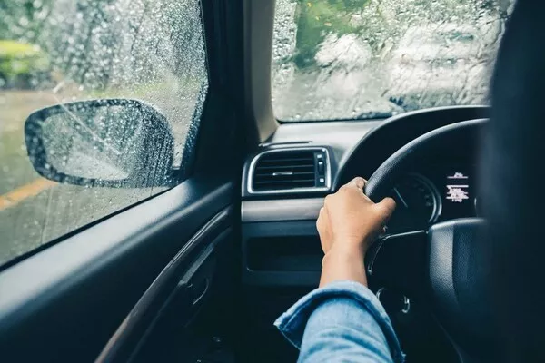 Man driving the car under the rain