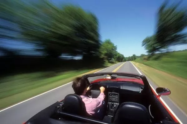 A picture of a man driving fast