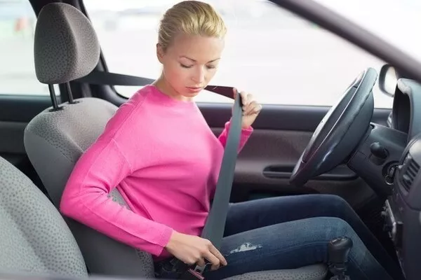 Woman fixing her seat belt